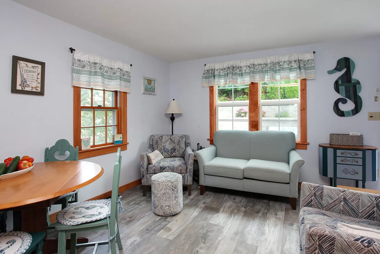 Bright living room with light blue couch and coastal art.